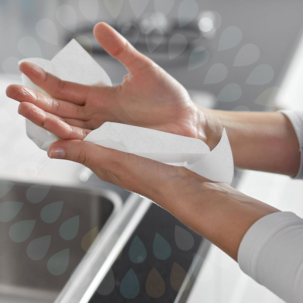 Person drying hand with kleenex paper hand towel, kimerbley-clark professionals paper products, toilet tissue, folded hand towels