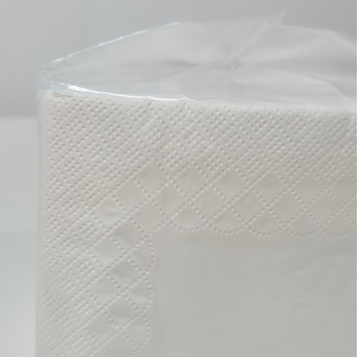 Whisper cocktail napkins, 250 napkins per pack, clear packaging with pink label, QT fold, cocktail glass on front, white cocktail napkins, code 6406, close up of embossing