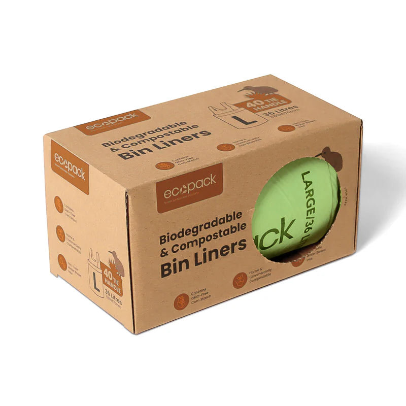 Cardboard box of eco-friendly bin liners with a green bin liner peeking out.