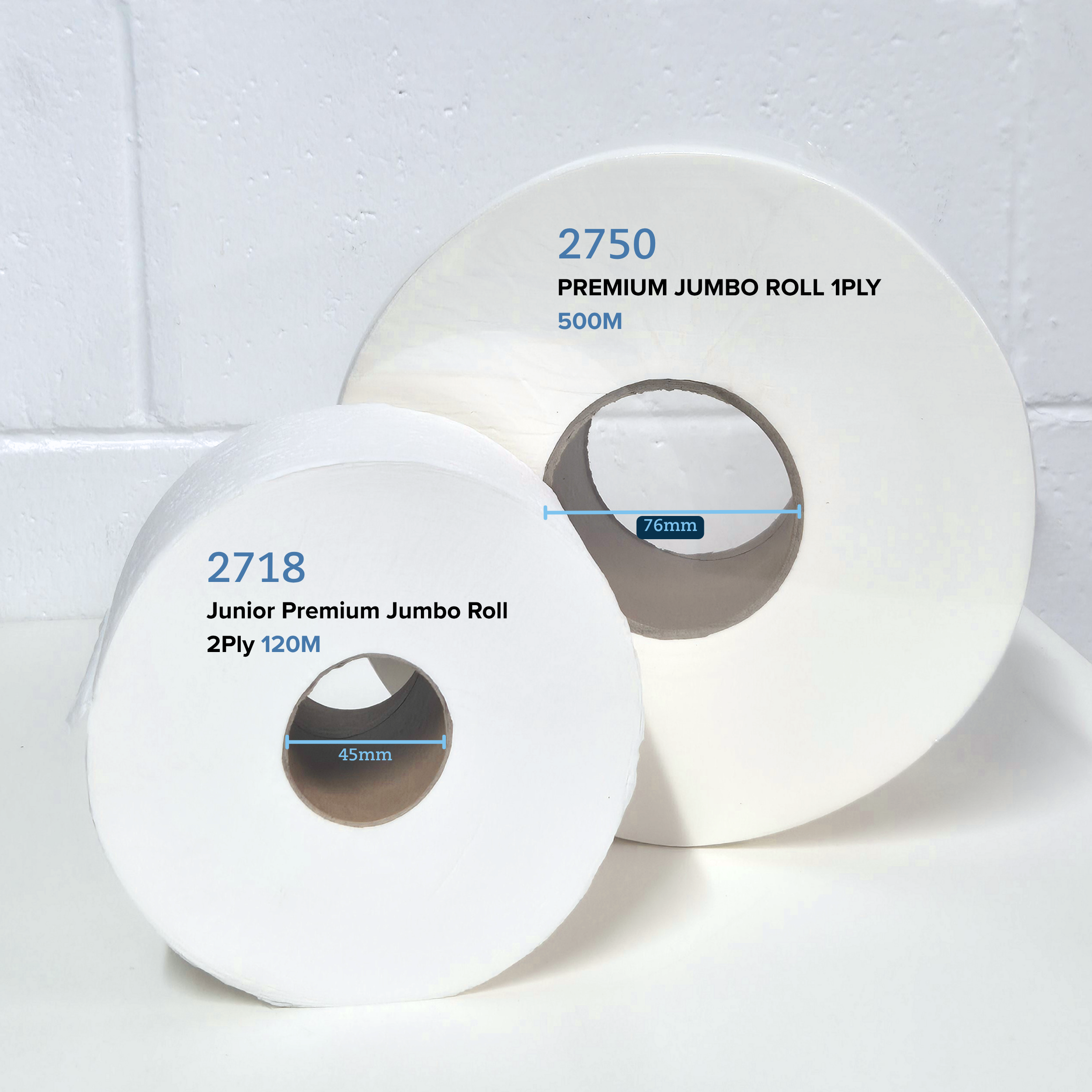 Comparison of Whisper 2718 Junior premium jumbo roll 2ply 120M and 2750 premium jumbo roll 1ply 500m on a white table with a white brick background