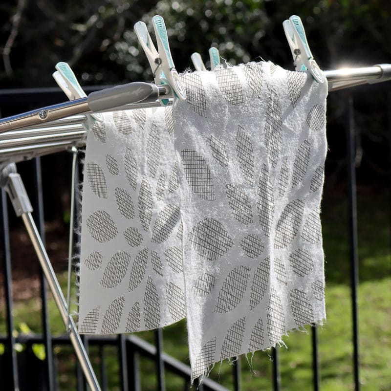 Ecopack, Australia, Box of eco-pack multi-purpose bamboo cloths with a sample cloth on a white background, whisper partners, 10 cloths per pack, reusable, hanging on the line, drying with pegs