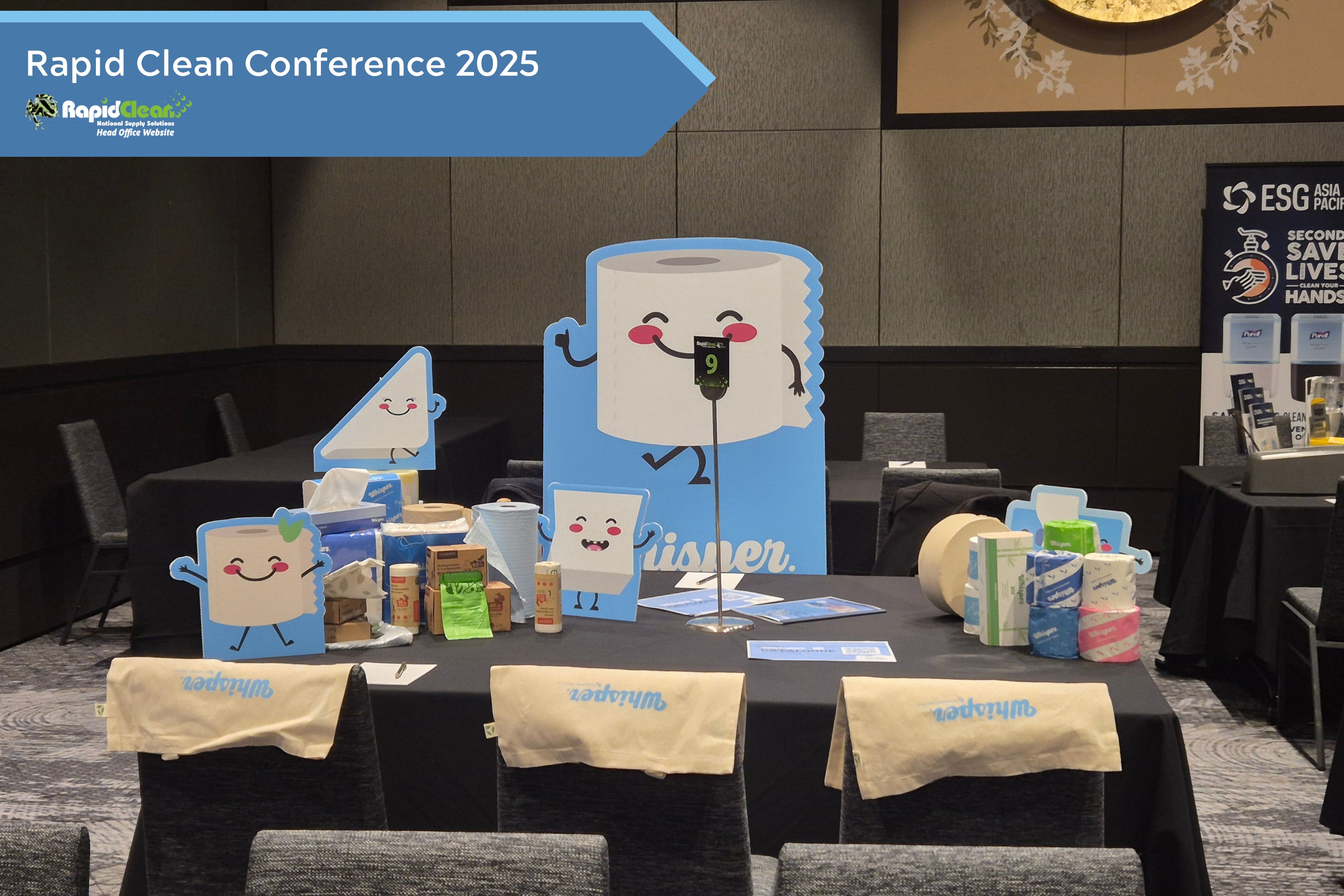 Whisper display stall at Rapid Clean conference 2025, tote bags, whisper characters
